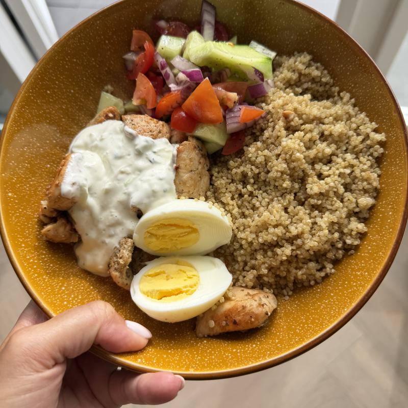 Quinoa with chicken, boiled egg, yoghurt sauce and tomato and cucumber salad