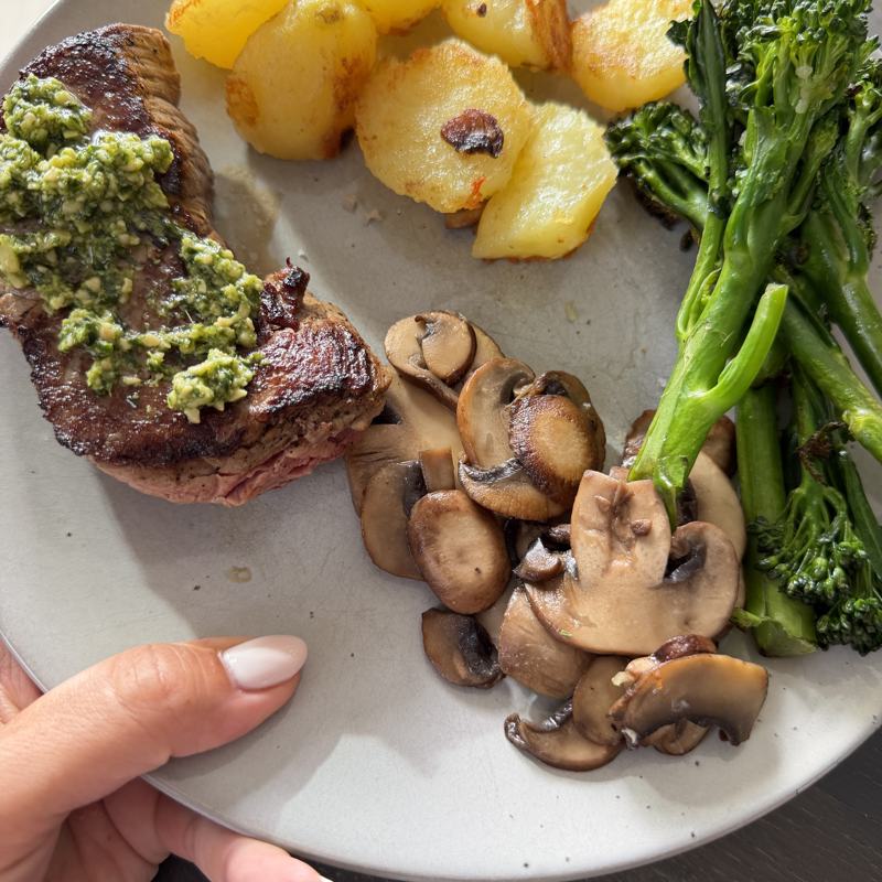 Steak with pesto, roast potatoes, mushrooms and broccolini