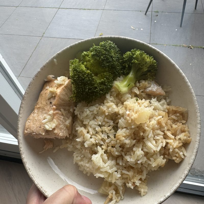 Chicken satay with rice, vegetables and a boiled egg