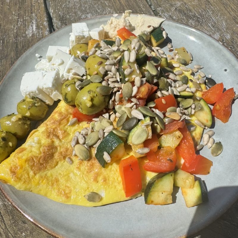 Omelette with courgette, peppers, olives and sunflower seeds
