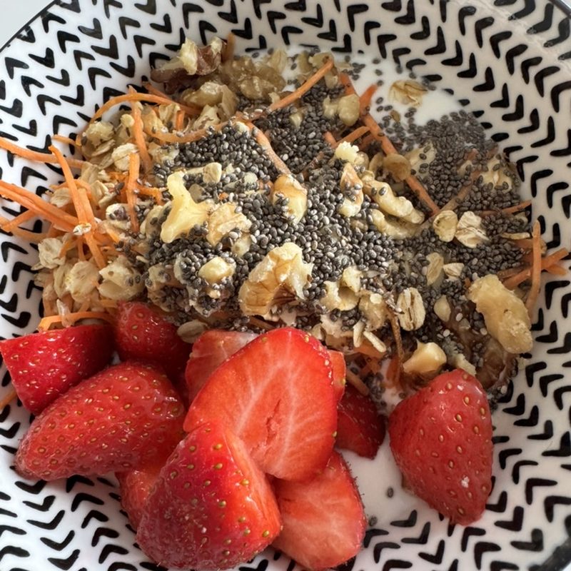 Oat bowl with strawberries, carrot, chia seeds and nuts
