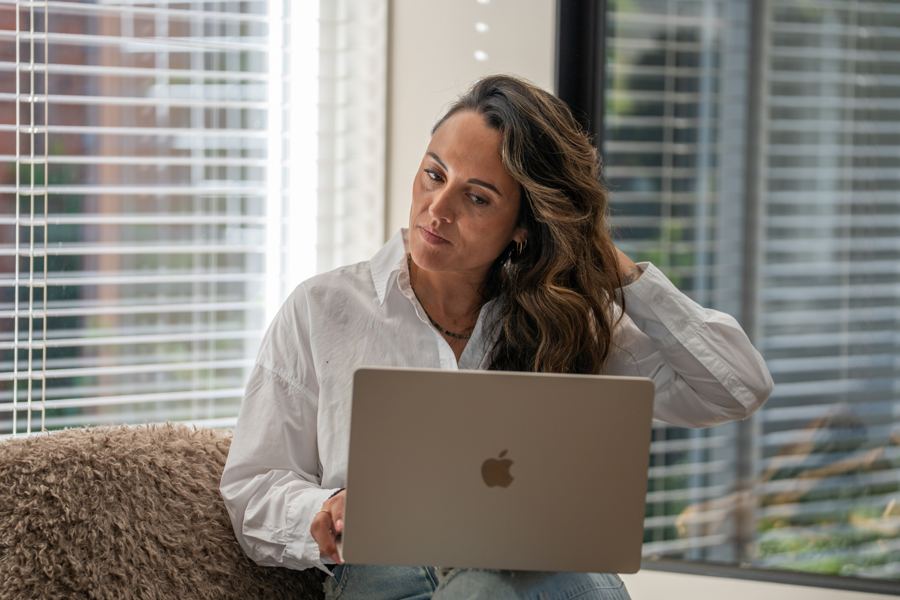Romy werkt geconcentreerd op haar laptop
